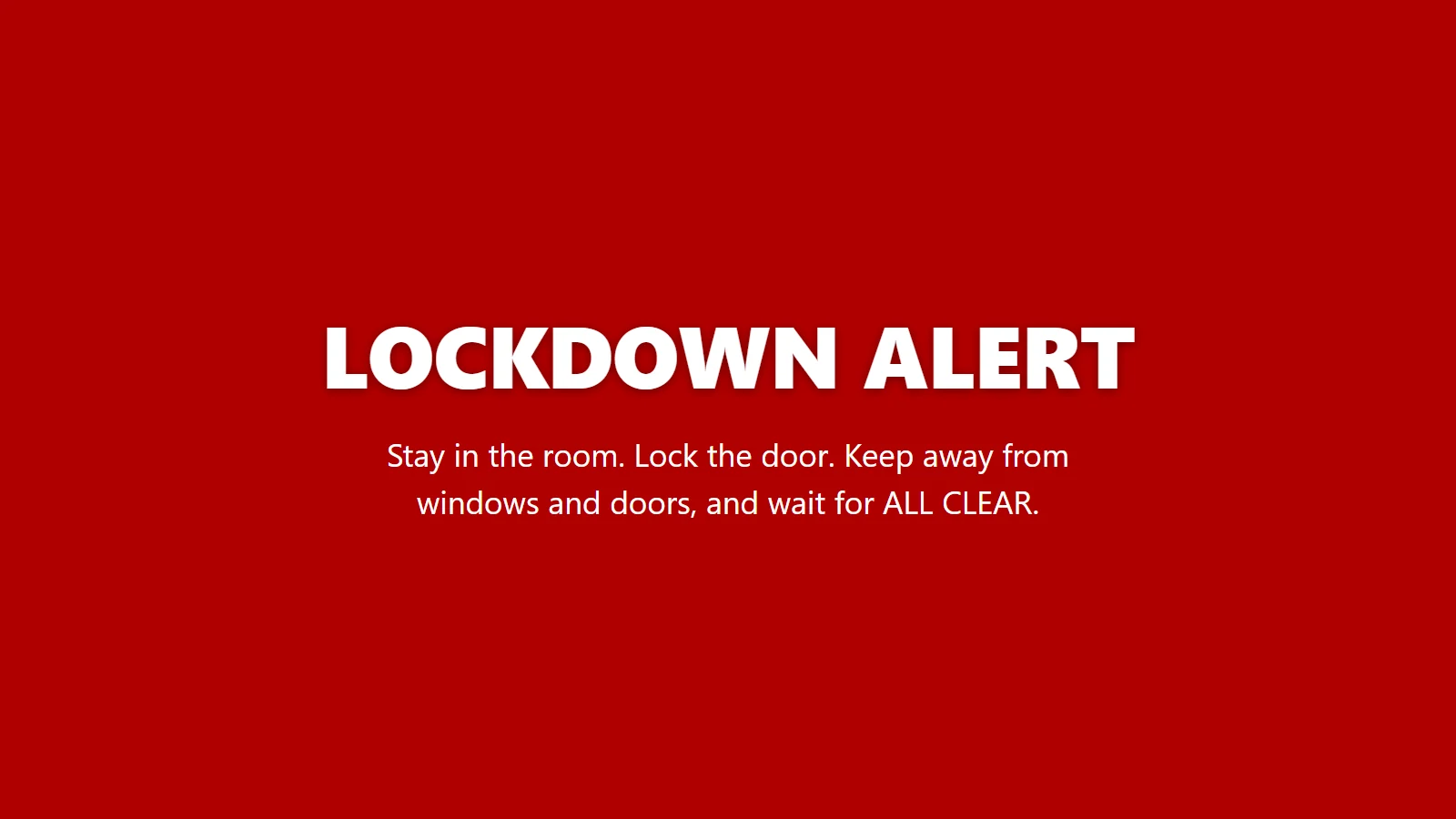 The red LOCKDOWN screen every enrolled PC and display shows: LOCKDOWN ALERT. Stay in the room. Lock the door. Keep away from windows and doors, and wait for ALL CLEAR.